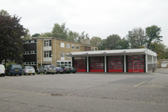 Luton Fire Station on Studley Road, with its red appliance bay doors and the three-storey building behind.